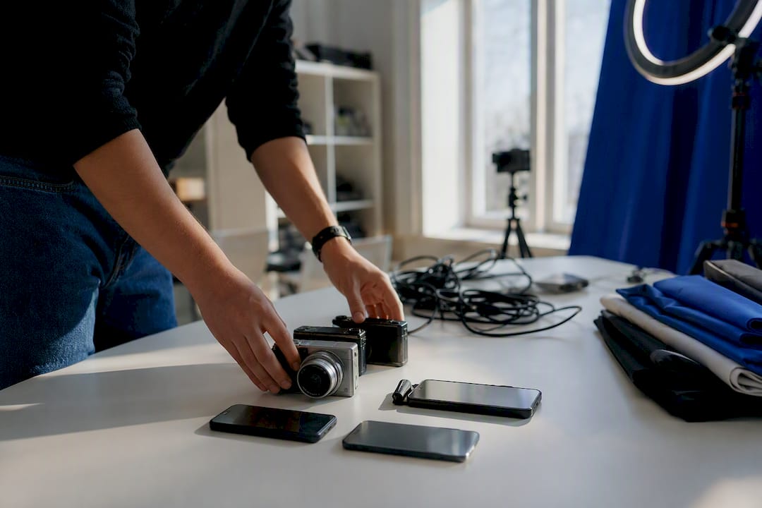 Hands arranging multiple cameras for batch shoot